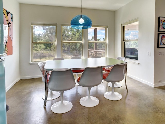 dining area featuring concrete flooring and plenty of natural light