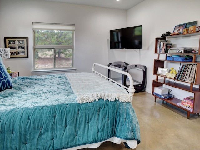 bedroom featuring concrete flooring