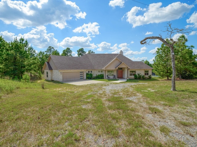 single story home with a front yard and a garage