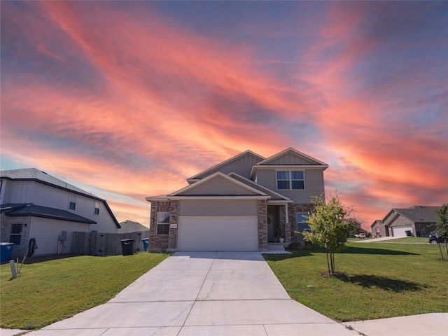 view of front of home featuring a lawn and a garage