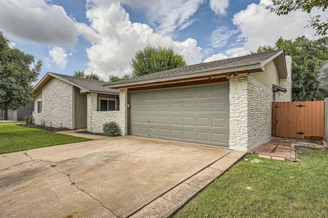 ranch-style house with a garage and a front lawn