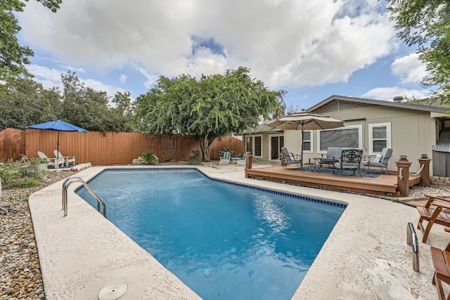 view of swimming pool with a deck