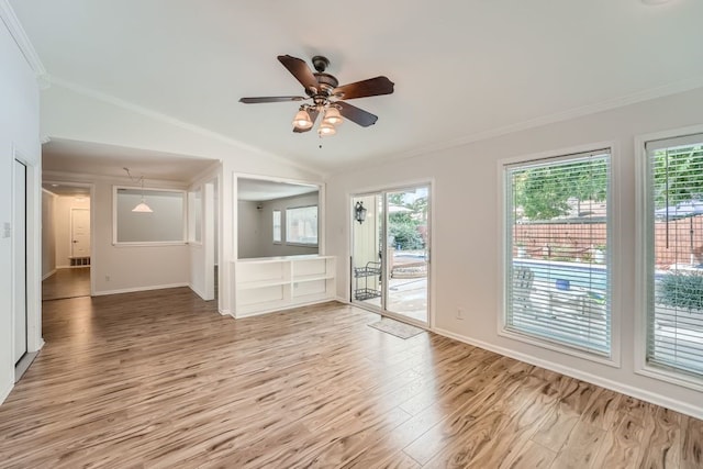 unfurnished living room featuring ceiling fan, ornamental molding, light hardwood / wood-style floors, and a wealth of natural light