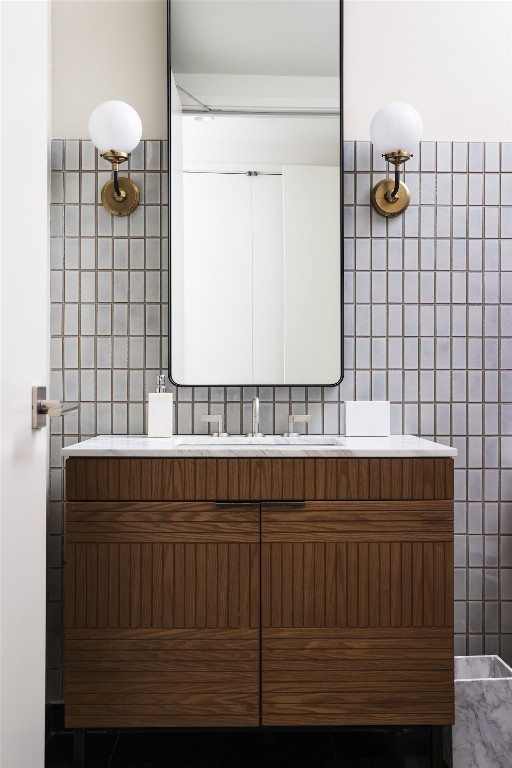 bathroom featuring tile walls and vanity