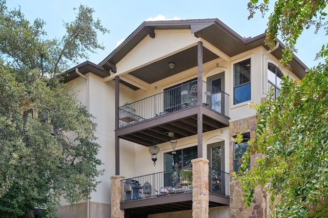 back of property featuring a balcony