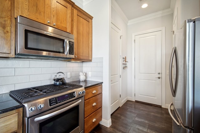 kitchen featuring tasteful backsplash, dark wood-type flooring, stainless steel appliances, and ornamental molding