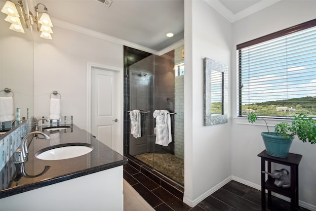 bathroom featuring crown molding, vanity, and an enclosed shower