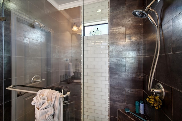 bathroom with crown molding and a shower with shower door