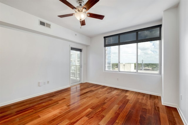 unfurnished room featuring ceiling fan and hardwood / wood-style flooring