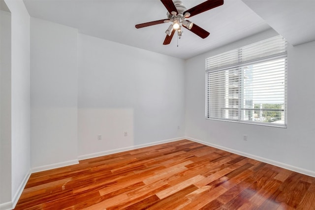 spare room featuring light hardwood / wood-style flooring and ceiling fan