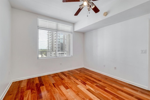 empty room with ceiling fan and light wood-type flooring