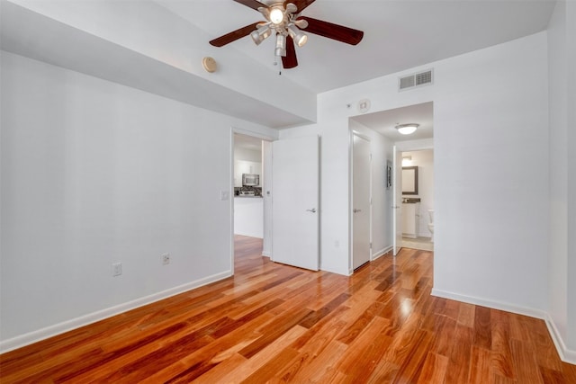 spare room featuring ceiling fan and light hardwood / wood-style floors