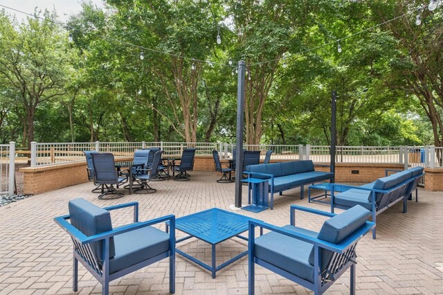 54 Rainey St Unit 1015, Austin, TX 78701 - view of patio / terrace with an outdoor living space and view of scattered trees