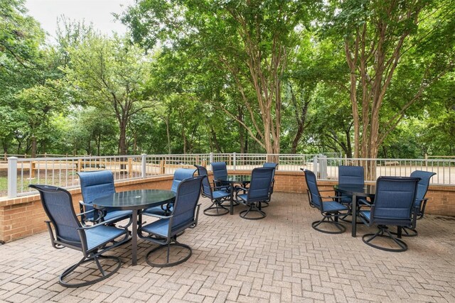 54 Rainey St Unit 1015, Austin, TX 78701 - view of patio / terrace featuring outdoor dining space and view of scattered trees