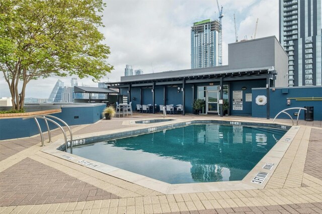 54 Rainey St Unit 1015, Austin, TX 78701 - community pool with a community hot tub, a patio, and a city view