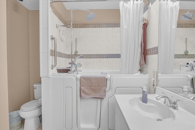 full bathroom featuring vanity, shower / bath combination with curtain, a textured ceiling, and toilet