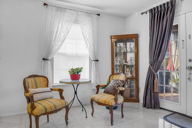 living area with light tile patterned flooring and plenty of natural light