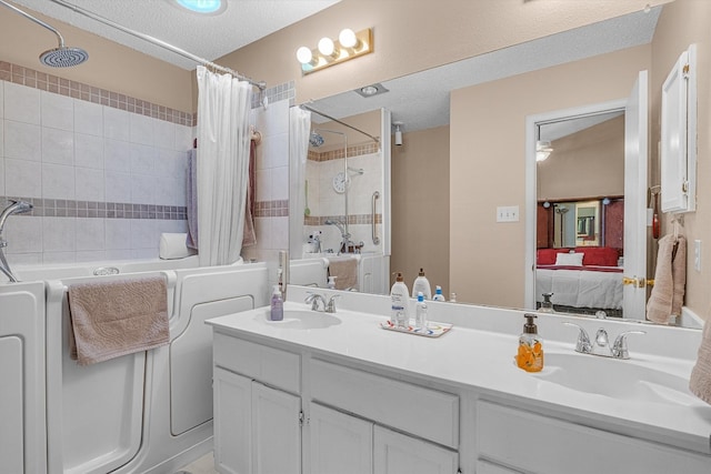 bathroom featuring a textured ceiling, independent shower and bath, and vanity