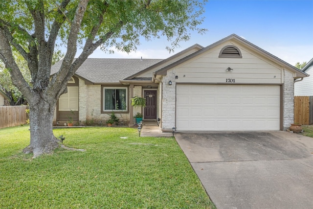 ranch-style house featuring a garage and a front yard