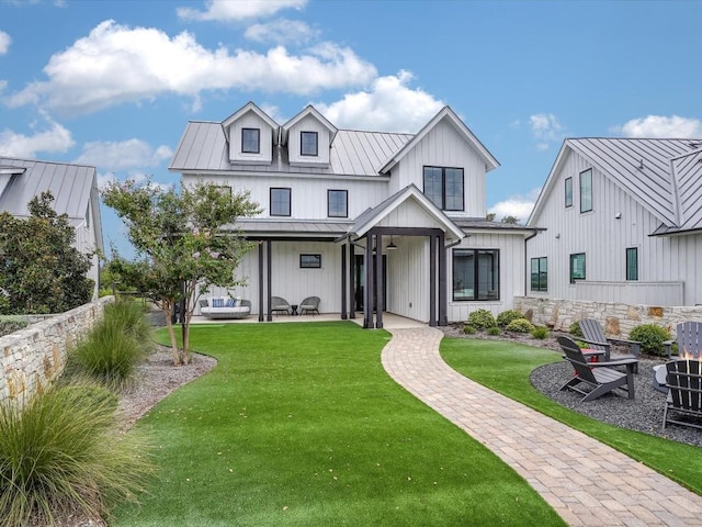 19601 Flying J Blvd Unit 15, Spicewood, TX 78669 - modern farmhouse style home featuring a standing seam roof, a patio, board and batten siding, metal roof, and a front lawn