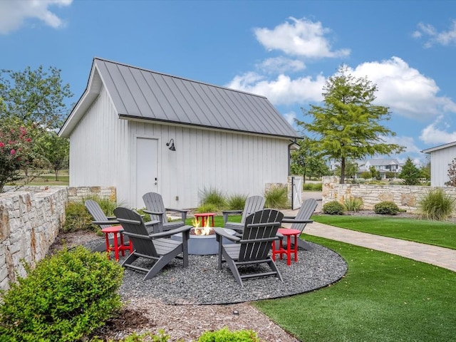 19601 Flying J Blvd Unit 15, Spicewood, TX 78669 - view of patio / terrace with a fire pit and an outbuilding
