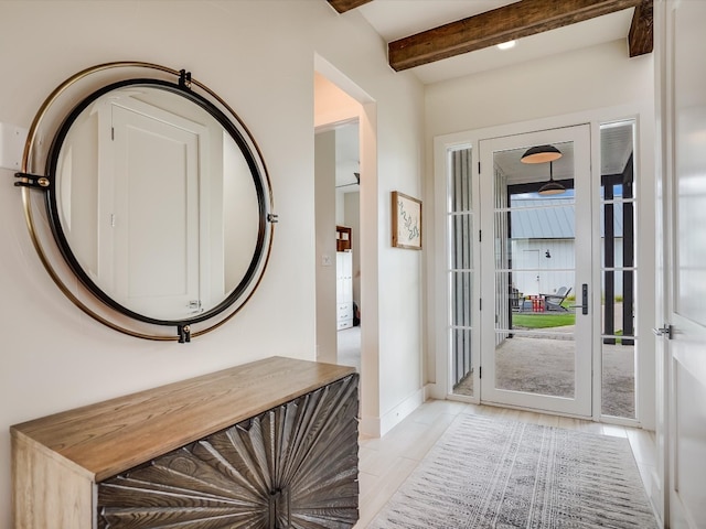 tiled foyer featuring beamed ceiling