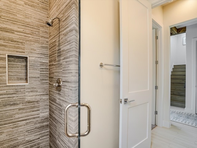 bathroom featuring a shower with door