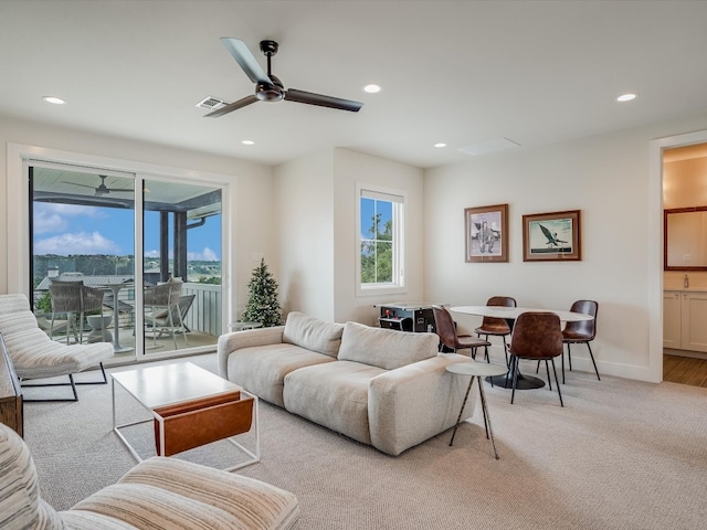 living room featuring ceiling fan and light colored carpet