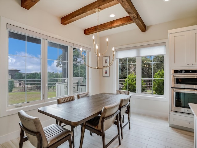 dining room featuring an inviting chandelier, beamed ceiling, and light hardwood / wood-style floors