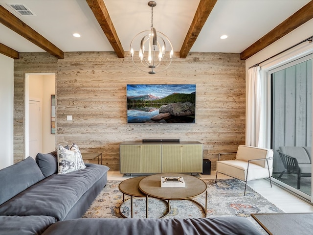 living room with wood-type flooring, wood walls, beamed ceiling, and a chandelier