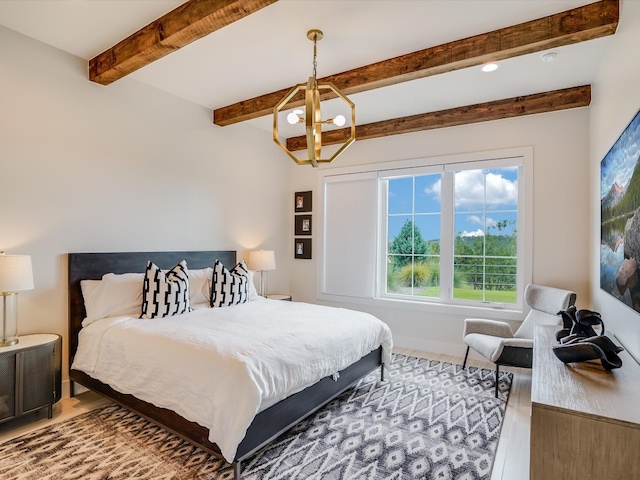 bedroom with a notable chandelier, wood-type flooring, and multiple windows