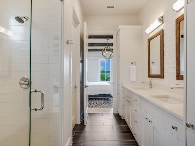 bathroom featuring vanity and an enclosed shower