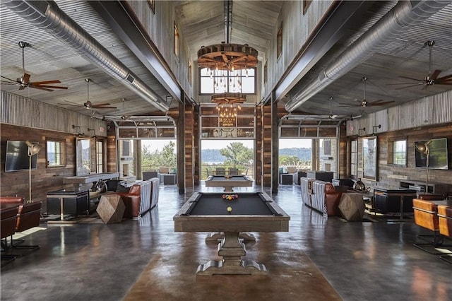 rec room featuring ceiling fan with notable chandelier, plenty of natural light, and high vaulted ceiling