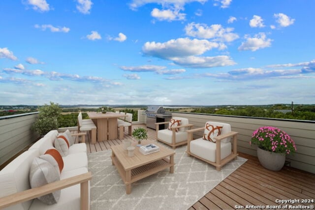 wooden deck with area for grilling and an outdoor hangout area