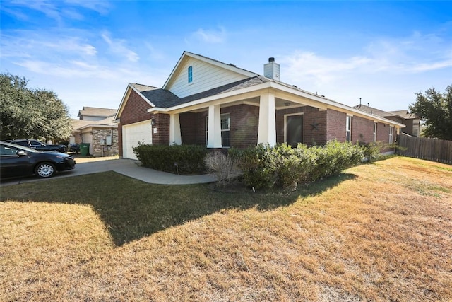 view of front of property with brick siding, a garage, a chimney, and driveway