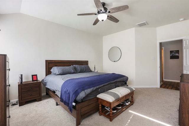 bedroom with vaulted ceiling, light colored carpet, and ceiling fan