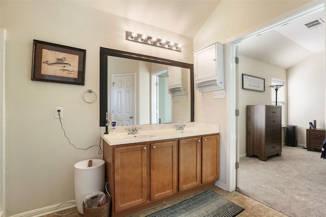 bathroom with lofted ceiling, double vanity, baseboards, and tile patterned flooring