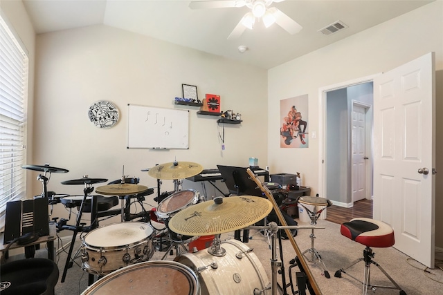 recreation room with ceiling fan, hardwood / wood-style flooring, and lofted ceiling