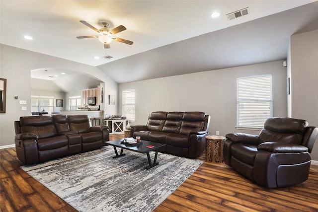 living area with dark wood finished floors, a ceiling fan, vaulted ceiling, arched walkways, and recessed lighting