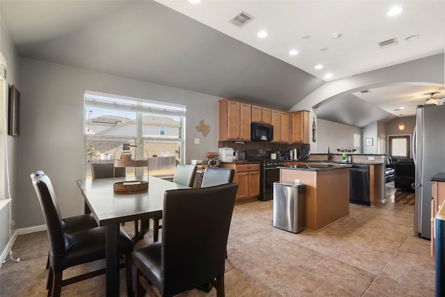 kitchen featuring black appliances, a center island, kitchen peninsula, vaulted ceiling, and light tile patterned floors