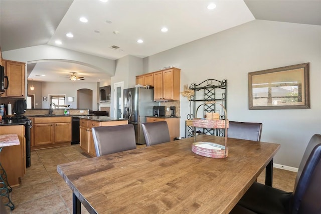 dining room featuring lofted ceiling, arched walkways, ceiling fan, recessed lighting, and light tile patterned flooring