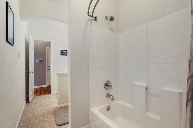 full bathroom with shower / bathtub combination with curtain, tile patterned flooring, and baseboards
