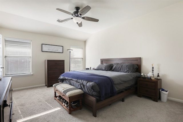 carpeted bedroom with ceiling fan and vaulted ceiling