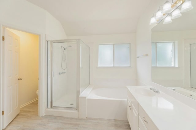 full bathroom featuring independent shower and bath, lofted ceiling, and a healthy amount of sunlight