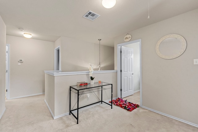 hallway with light colored carpet