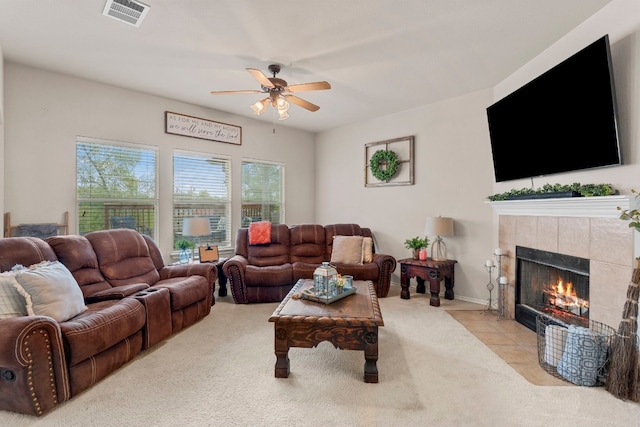 living room with light carpet, ceiling fan, and a fireplace