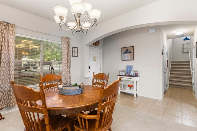 dining space with an inviting chandelier and light tile patterned floors