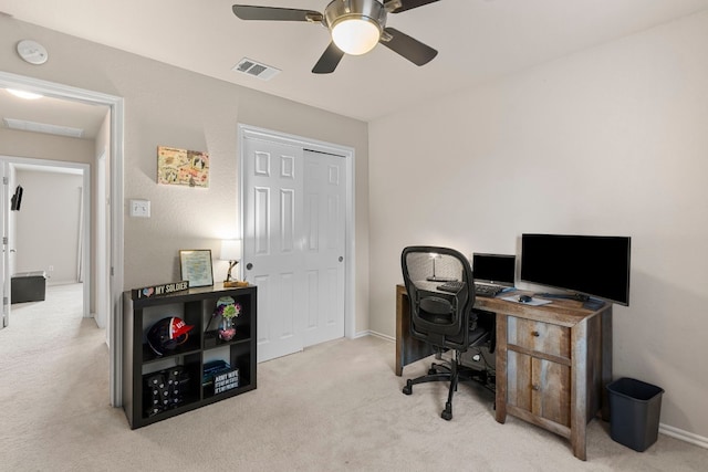 office space with ceiling fan and light carpet