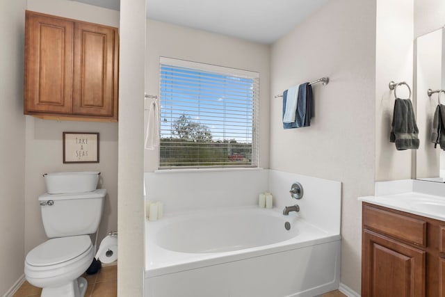 bathroom featuring vanity, a bathtub, tile patterned flooring, and toilet