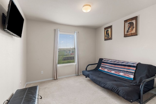 living area featuring light carpet